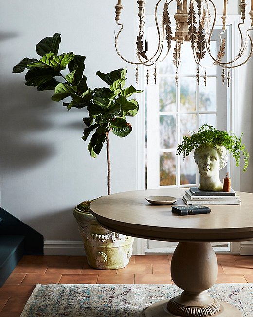A pedestal table, a tole chandelier, and classical pottery in a simple, spare setting illustrates the Med marriage of elegance and ease. For a similar table, see the Axiom. Shop a similar planter here.
